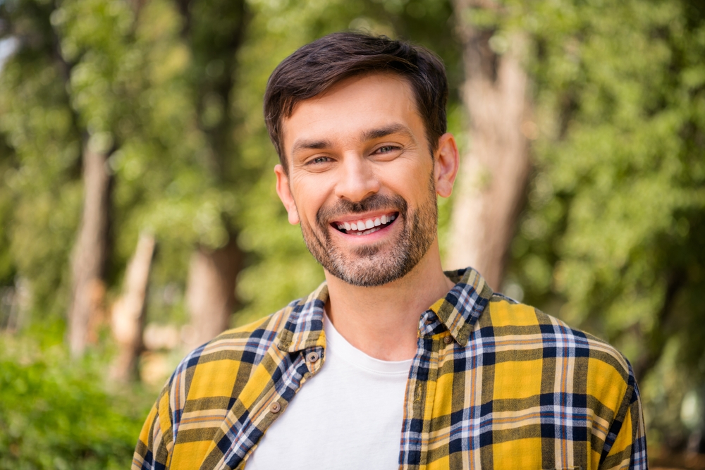 A smiling patient outdoors.