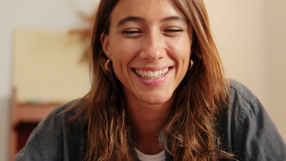 A smiling patient in a warm interior.