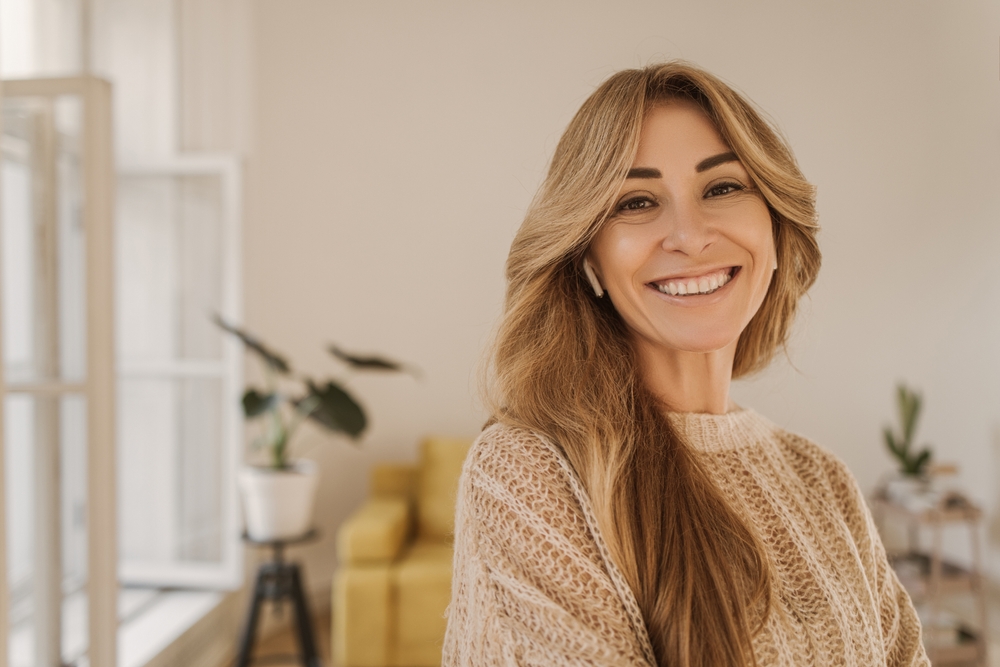 A smiling patient in a warm interior.