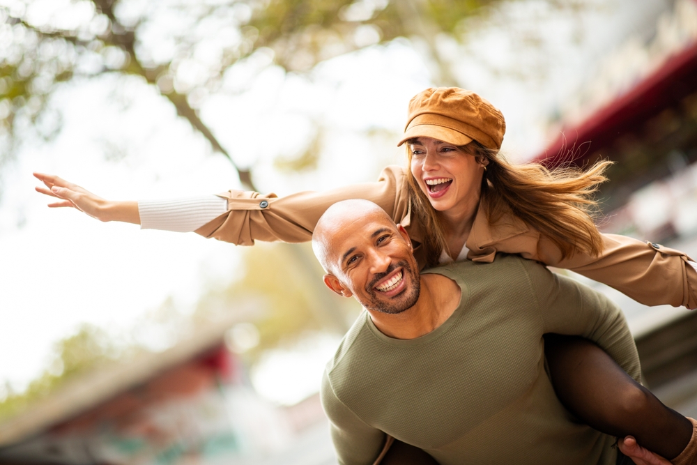 A family smiling together outdoors.