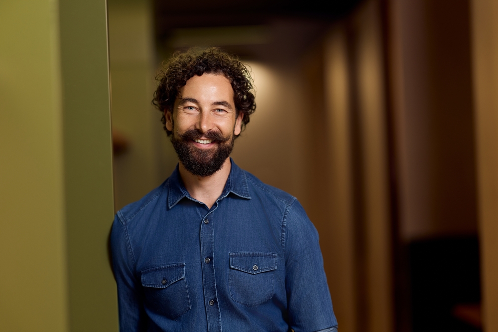 A smiling patient in a softly lit room.